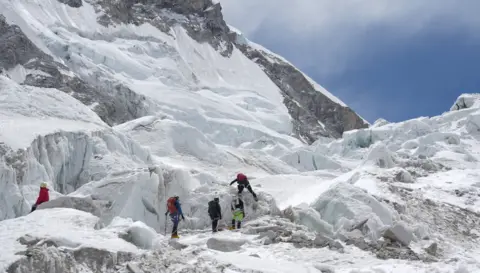 Climbers like Purnima Shrestha, who is in the party seen here, are acclimatising at Base Camp but cannot attempt to summit until the route is prepared