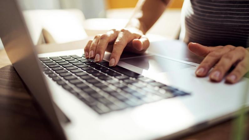 mãos de mulher digitando no computador