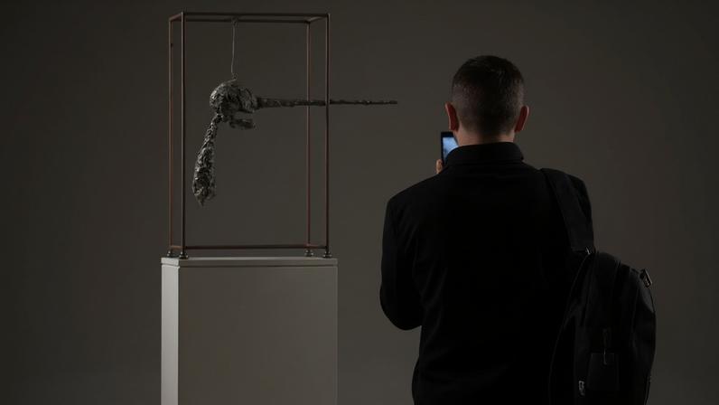 A person walks past Alberto Giacometti's "Le Nez", part of the Macklowe Collection, at Sotheby's on November 5, 2021, in New York City. (Photo ANGELA WEISS/AFP via Getty Images)