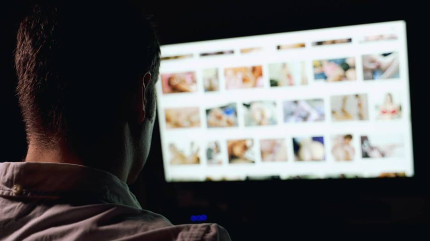 Man browsing porn site late at night.