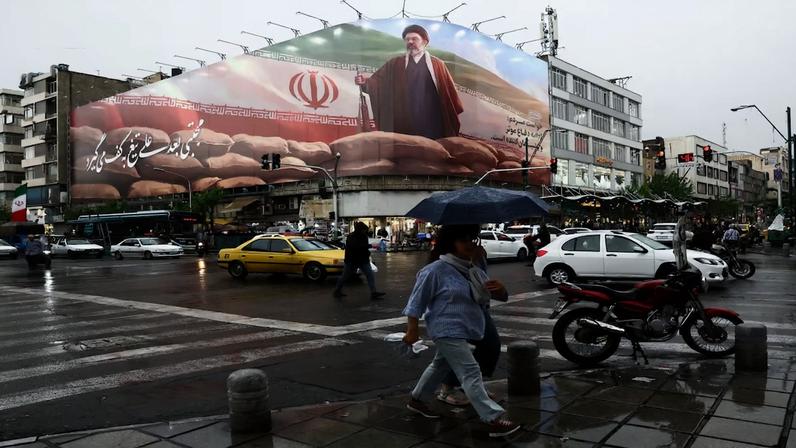 Pessoas caminham perto de um outdoor com a imagem do novo Líder Supremo do Irã, Mojtaba Khamenei, em meio a um cessar-fogo entre os EUA e o Irã, em Teerã , Irã