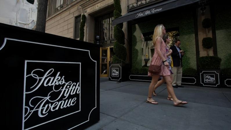 A woman walking past a store