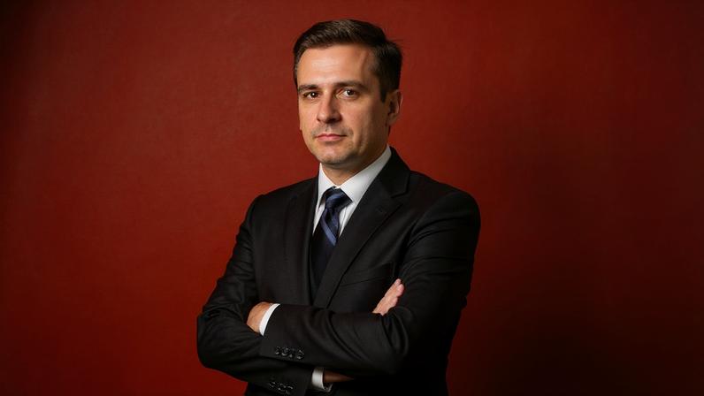Photo Illustration of Man in Suit on a Gradient Background with Crosses all Around Him