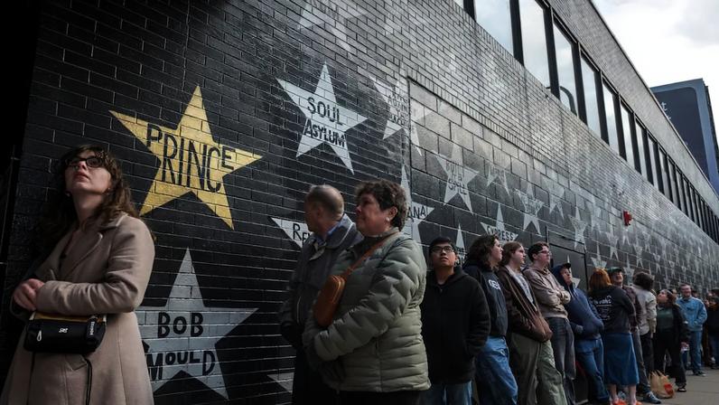 People line outside the First Avenue & 7th St Entry performance space in downtown Minneapolis on March 26, 2026, which is housed in a former bus station that was featured in the 1984 film “Purple Rain,” and propelled Prince into mega stardom. This year is the 10th anniversary of the artist’s death and The New York Times made a pilgrimage to the city where he lived and worked.