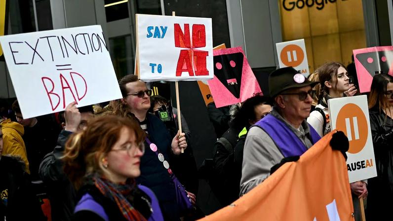 Protesters gather with banners and placards outside the offices of Google Deepmind at a protest organized by PauseAI UK and other groups concerned in controlling the development of advanced Artificial Intelligence systems, in London on February 28, 2026.