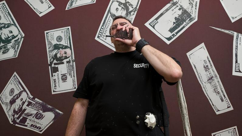 Photo Illustration of Security Guard with Money Falling all around him