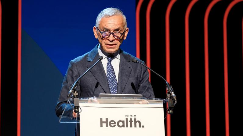 Lord Ara Darzi speaks while standing at a podium