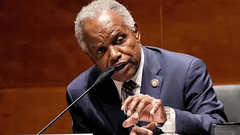 Reuters US Representative wears a dark suit and leans over to speak into a table microphone during a hearing of the House of Representatives' Financial Services Committee on 30 June 2020.