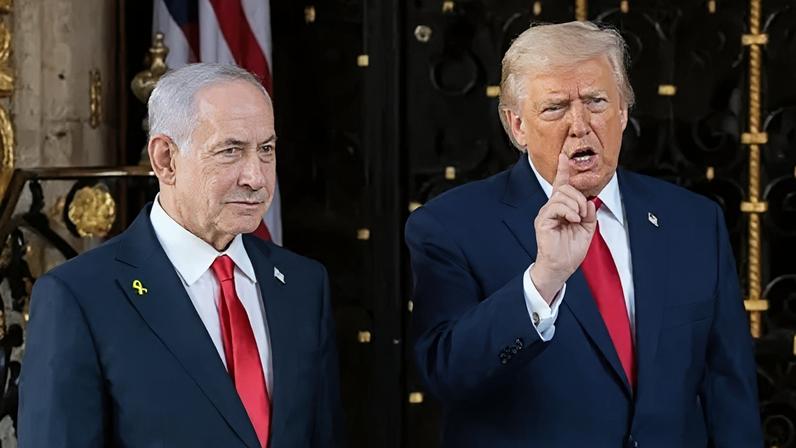 U.S. President Donald Trump speaks to the media next to Israeli Prime Minister Benjamin Netanyahu.