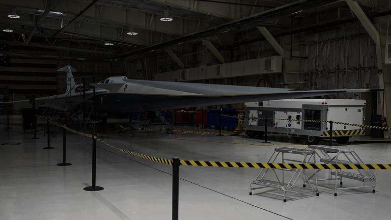 NASA’s X-59 quiet supersonic research aircraft sits inside Hangar 4826 at NASA’s Armstrong Flight Research Center in Edwards, California, on Nov. 18, 2025. The aircraft is the centerpiece of NASA’s Quesst mission, which aims to demonstrate quiet supersonic flight and reduce the disruptive sonic boom to a quieter sonic thump.