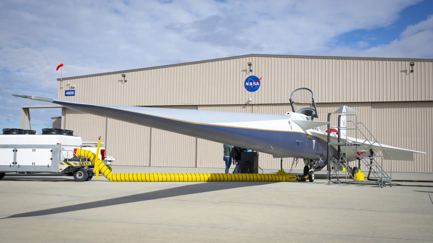 NASA’s X-59 quiet supersonic airplane sits parked in front of its new hangar home at the agency’s Armstrong Flight Research Center in California. The facility originally was constructed in 1968 and for nearly 60 years has hosted a number of research aircraft and programs.