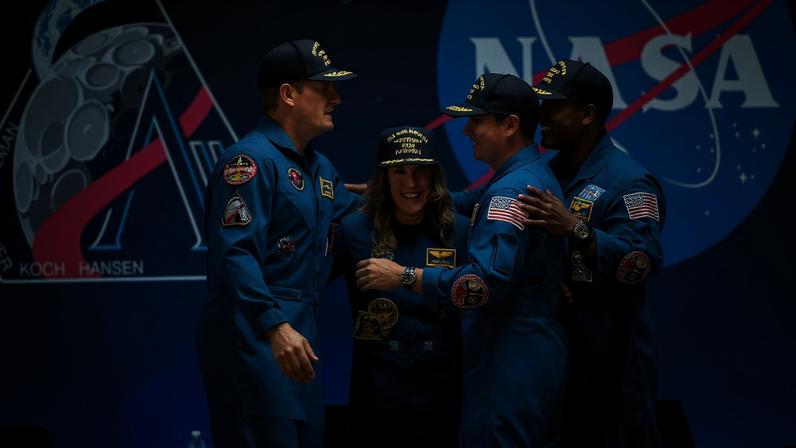 The Artemis astronauts hug as they are welcomed back to Houston at Ellington Airport on Saturday, April 11, 2026.