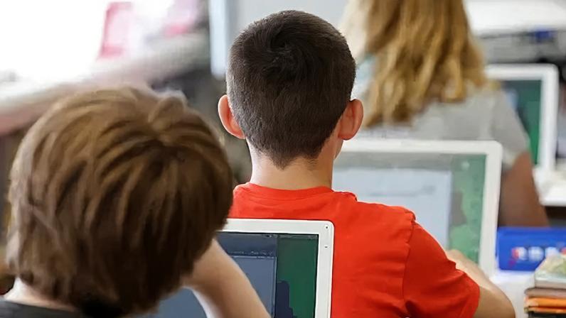 Getty Images Close up image of students using laptops in a classroom.