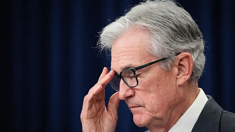 Getty Images Outgoing Federal Reserve chair Jerome Powell wearing a white shirt and dark suit jacket readjusts his glasses while speaking to the press.