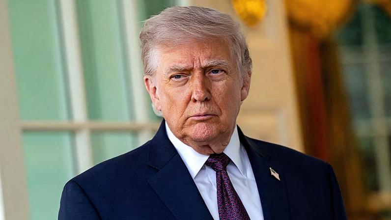 US President Donald Trump stands outside the Oval Office