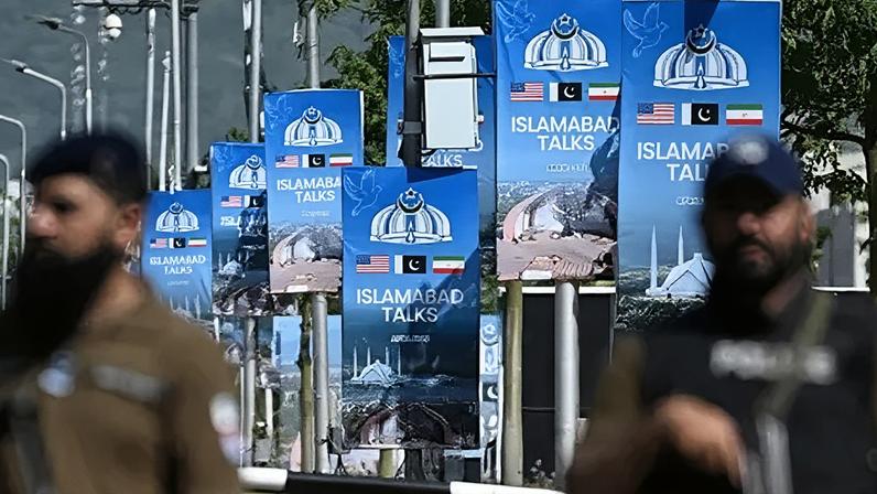 AFP via Getty Images Security personnel stand guard at a security checkpost along a road temporarily closed near the Serena Hotel at the Red Zone area in Islamabad on April 20, 2026.