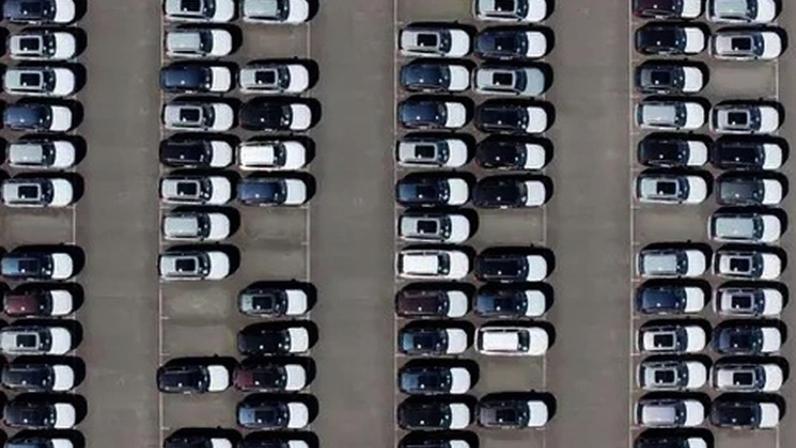 An aerial view of whit and black imported new cars on the quayside of Alexandra Dock at Grimsby Port.