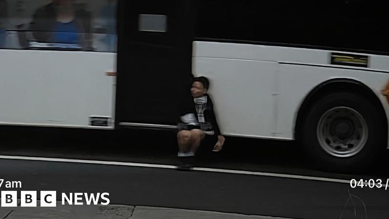 CCTV captures boy dangling off side of a bus