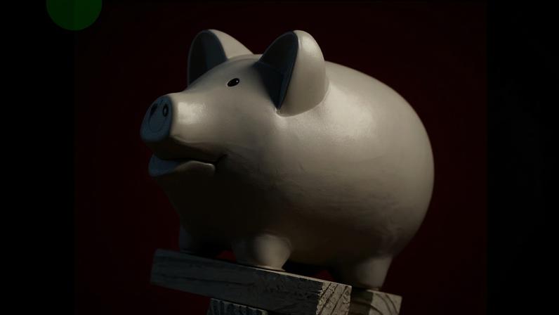 BBC A piggy bank balanced on top of some falling wooden blocks
