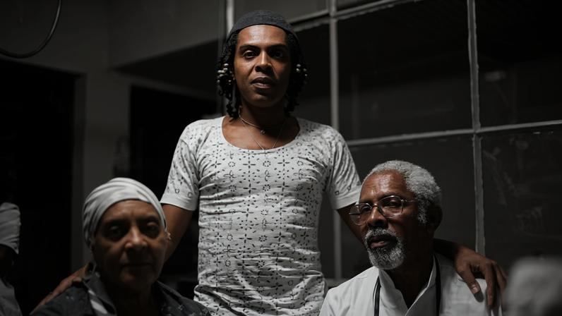 Retrato íntimo de Gilberto Gil ao lado dos pais, em cena doméstica captada por Lita Cerqueira, revela a proximidade que marca o olhar da artista sendo mais encontro do que registro