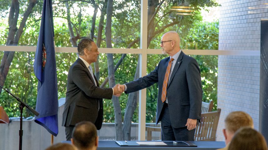 Mark Johnson, left, interim CEO of UNOS, and John Koelling, director of the Aeronautics Research Directorate at NASA's Langley Research Center, shake hands during a signing ceremony marking an agreement to study drone transport for organs.