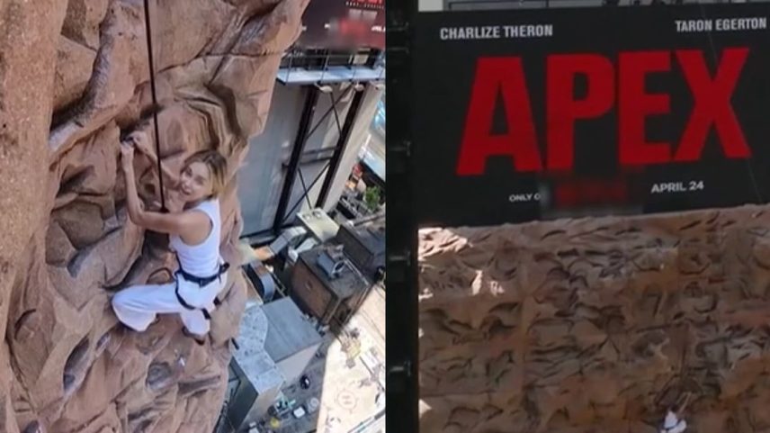 Charlize Theron escalando um edifício na Times Square, sem dublês, durante divulgação de 'O Jogo do Predador'.