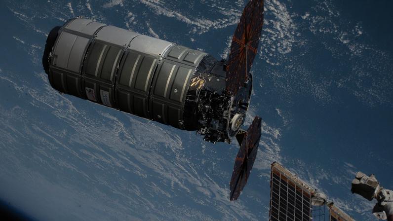 The Cygnus XL cargo spacecraft, carrying over 11,000 pounds of new science experiments, lab hardware, and crew supplies, is pictured moments before its capture with the Canadarm2 robotic arm.