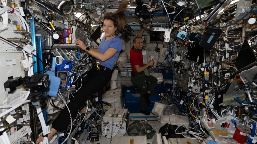Expedition 74 flight engineers Sophie Adenot and Chris Williams work together inside the International Space Station’s Columbus laboratory module to install and activate new research gear.