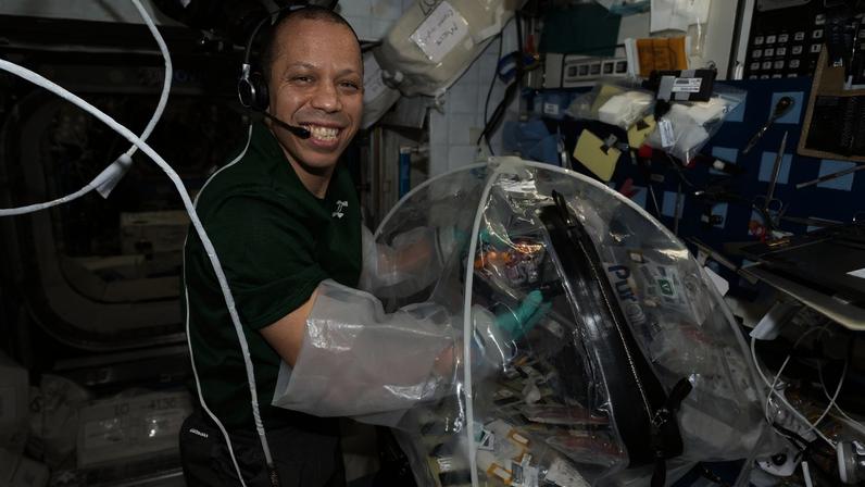 NASA astronaut and Expedition 74 flight engineer Chris Williams configures research hardware inside a portable glovebag for a biotechnology investigation exploring how bacteria affect heart tissue in the microgravity environment. Results from the MVP (Multi-use Variable-g Platform) Cell-09 experiment could lead to advanced methods for preventing or treating heart damage in humans living on and off the Earth.