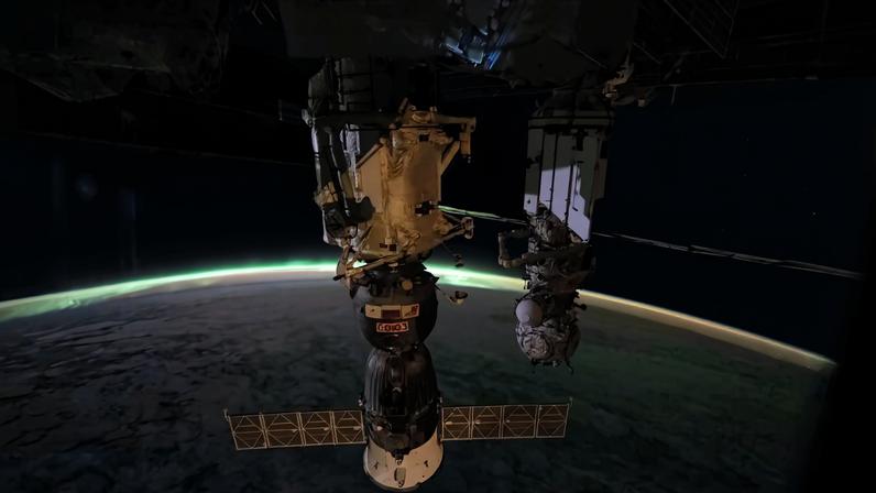 The aurora australis arcs above Earth’s horizon and fades into the airglow as the International Space Station orbited 265 miles above the Indian Ocean east of Perth, Australia, at approximately 2:03 a.m. local time. In the foreground, the Soyuz MS-28 crew spacecraft is shown docked to the Rassvet module. In the background, the Pirs docking module is attached to the Nauka science module.