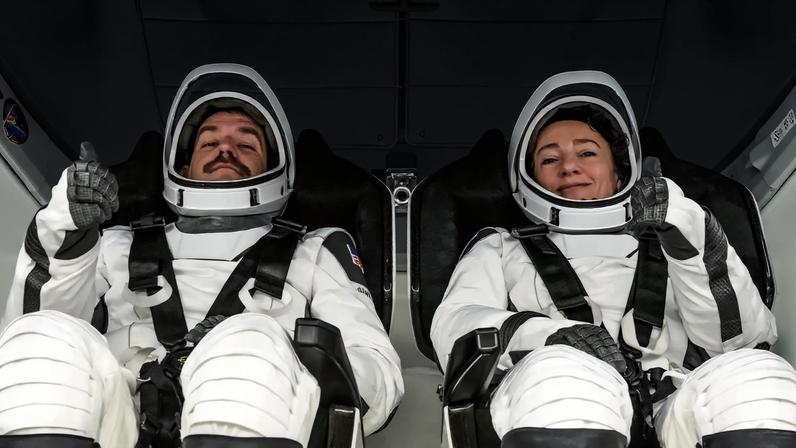 NASA astronauts (from left) Jack Hathaway and Jessica Meir are photographed on Jan. 12, 2026, in their pressure suits and inside the Dragon spacecraft during the Crew Equipment Interface Test at NASA’s Kennedy Space Center in Florida. The goal of the training is to rehearse launch day activities and get a close look at the spacecraft that will take them to the International Space Station.