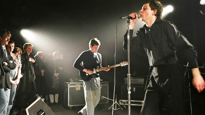 Bernard Sumner (left) and Ian Curtis perform with Joy Division.