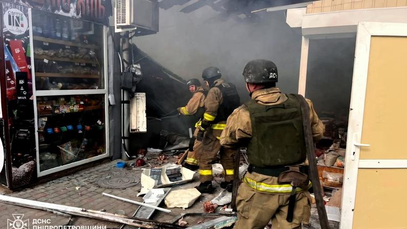 Bombeiros apagam um incêndio em um mercado após um ataque em Nikopol, em meio à invasão russa da Ucrânia