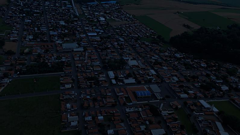 Vista aérea de Taiúva SP, com área urbana e praça central sob céu azul