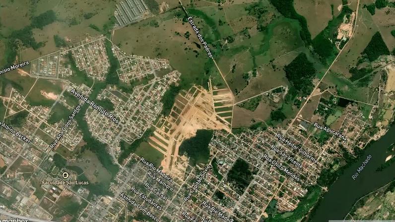 Vista aérea de Ji-Paraná ao entardecer, com o rio Machado cortando a cidade
