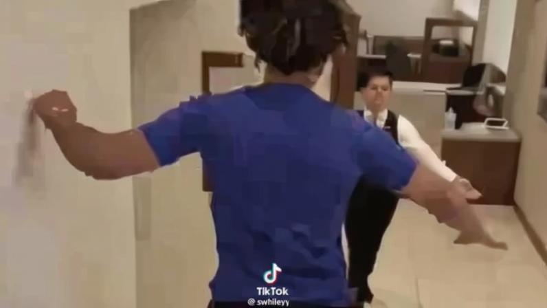 A guy leaps down the stairs in a Scientology Center.