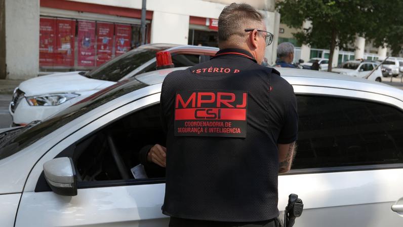 Agentes da Coordenadoria de Segurança e Inteligência (CSI) do Ministério Público do Rio de Janeiro que participam da Operação Carta de Corso se deslocam em frente à Corregedoria de Polícia