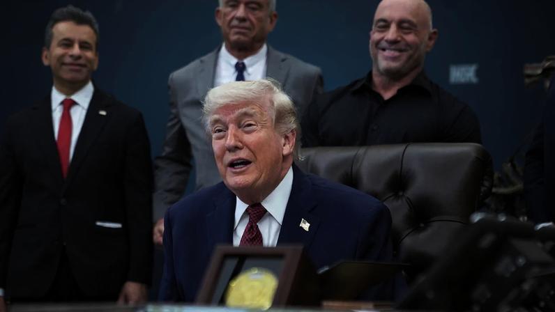 WASHINGTON, DC - APRIL 18: U.S. President Donald Trump makes an announcement on researching the effects of psychedelic drugs in medical treatment for veterans, on Saturday, April 18, 2026 in the Oval Office at the White House in Washington, D.C. FDA Commissioner Martin Makary, HHS Secretary Robert F. Kennedy Jr. and podcast host Joe Rogan, at rear, were among those who joined Trump. (Photo by Allison Robbert/For The Washington Post via Getty Images)