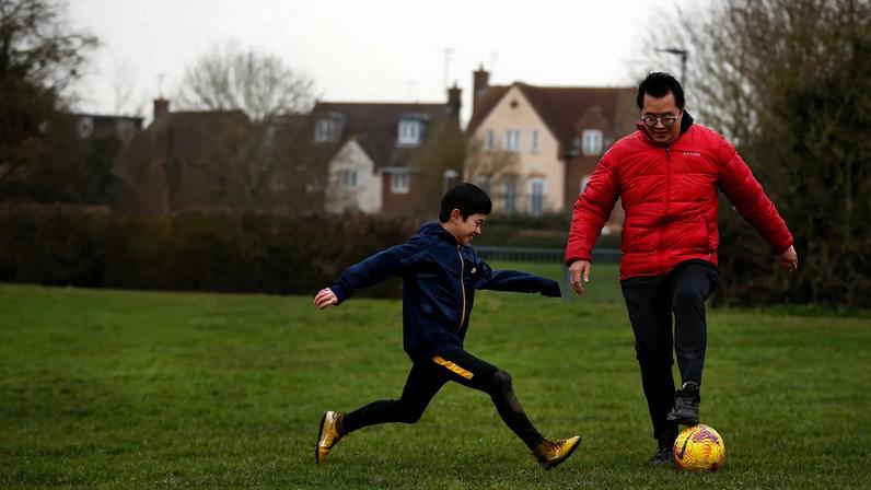 A family who arrived in Britain from Hong Kong plays football in Chelmsford on January 26, 2021.