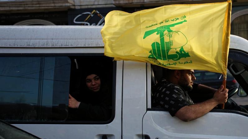 Displaced residents hold a Hezbollah flag as they celebrate while returning to their villages following a ceasefire between Israel and Hezbollah, in Zefta, southern Lebanon, Friday, April 17, 2026. (AP Photo/Hassan Ammar)