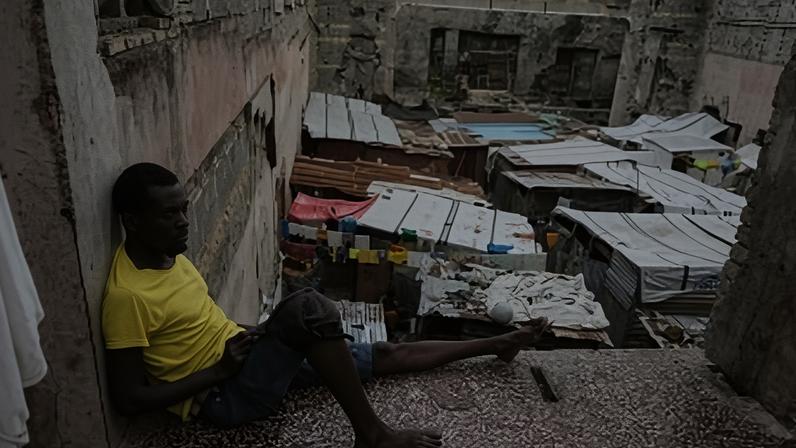 A man rests at a shelter for families displaced by gang violence Port-au-Prince, Haiti, Wednesday, March 18, 2026. (AP Photo/Odelyn Joseph)