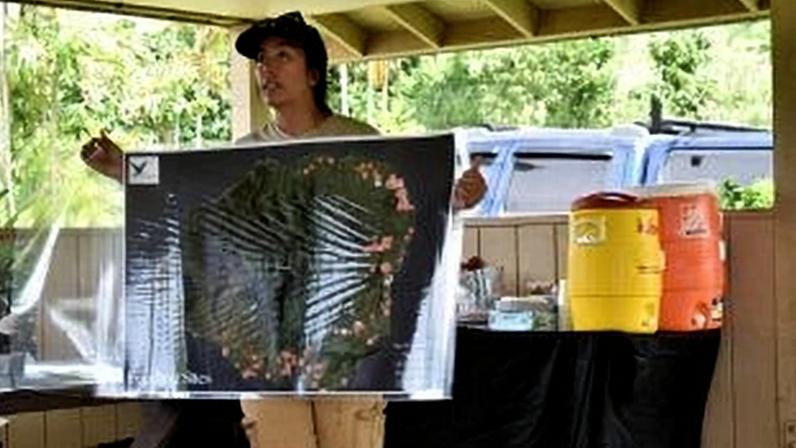 Nākai’elua Villatora, of the E Ola Kākou Hawai’i organization, presents the nonprofit’s coconut rhinoceros beetle-mapping project during a community workday at Prince Kūhiō Park in Poʻipū, Kauaʻi, on April 11 2026. (Noelle Fujii-Oride/Honolulu Civil Beat via AP)