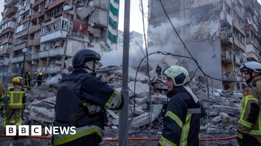 Fire crews survey scene of apartment strike in Kyiv