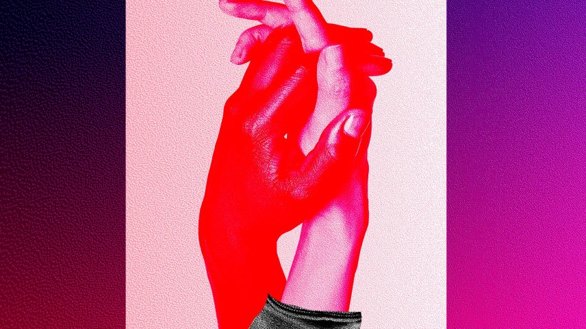One hand goes over a phone screen and holds another hand.