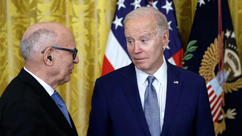 President Joe Biden(left) awards businessman and philanthropist Fred Eychaner a 2021 National Medal of Art during a ceremony in the East Room of the White House.