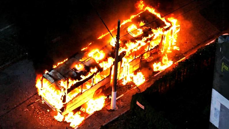 Ônibus incendiado na altura do km 230 da via Dutra, sentido São Paulo-Rio de Janeiro, no terceiro dia de terror provocado pelos ataques do PCC em 2006; ao menos 36 ônibus haviam sido incendiados no dia 14 de maio daquele ano