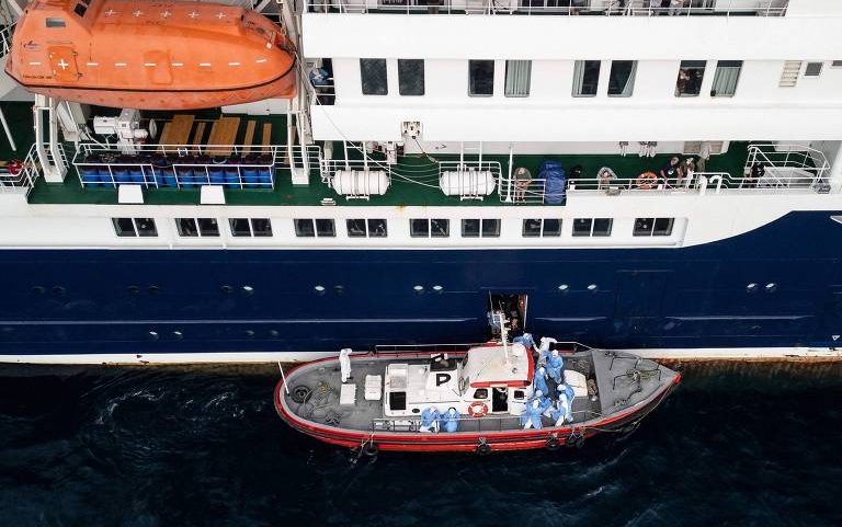 Vista aérea mostra equipes de saúde auxiliando pacientes a embarcar em uma embarcação a partir do cruzeiro MV Hondius, ancorado ao largo do porto da Praia, capital de Cabo Verde, em 6 de maio de 2026