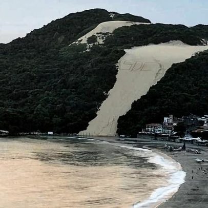 Sigla de facção criminosa é escrita na areia do Morro do Careca, em Natal