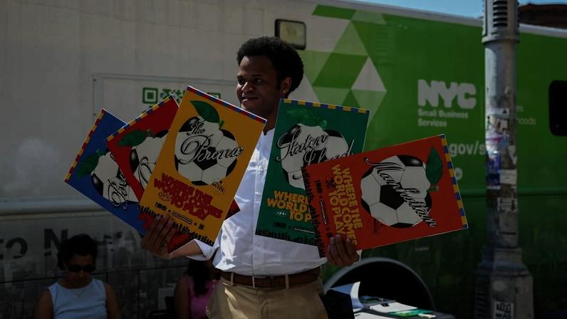 Jacques Brunvil exibe pôster da Copa do Mundo durante evento promovido pelo SBS no bairro Little Haiti, em Nova York