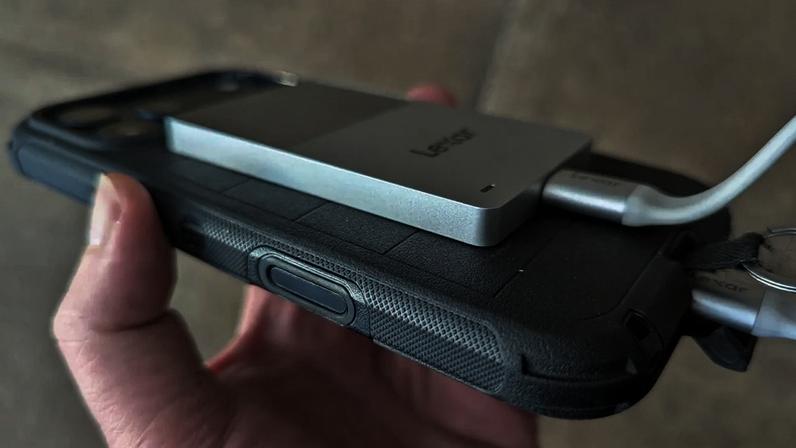 The drive is super thin and light, and is dwarfed by the iPhone.